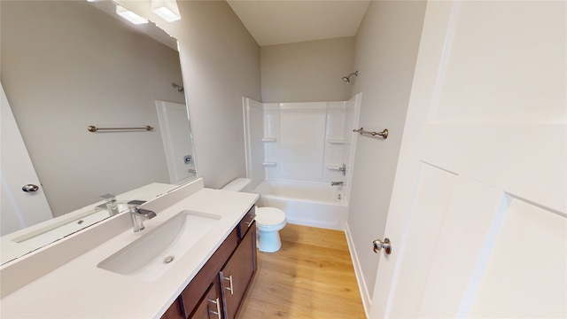 full bath featuring vanity, toilet, wood finished floors, and bathtub / shower combination