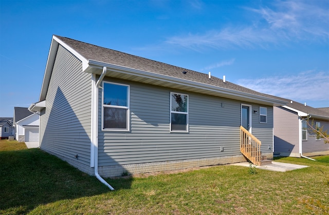 rear view of house featuring a lawn