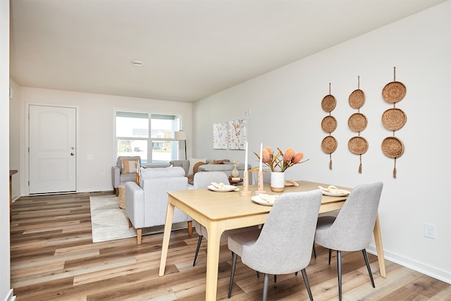 dining space with wood-type flooring