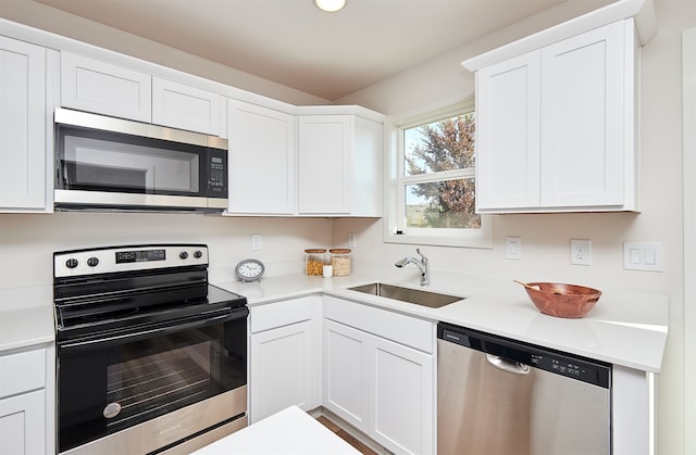 kitchen featuring white cabinets, sink, and stainless steel appliances