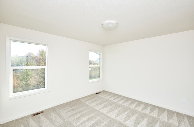 unfurnished room with carpet flooring