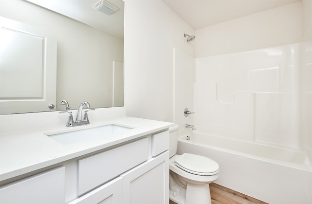 full bathroom with toilet, vanity, wood-type flooring, and bathing tub / shower combination