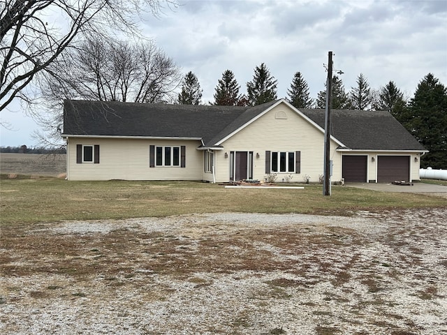 single story home with a front yard and a garage