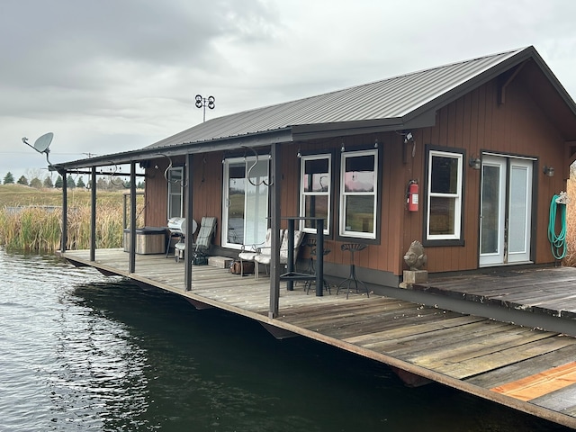 rear view of house featuring a water view