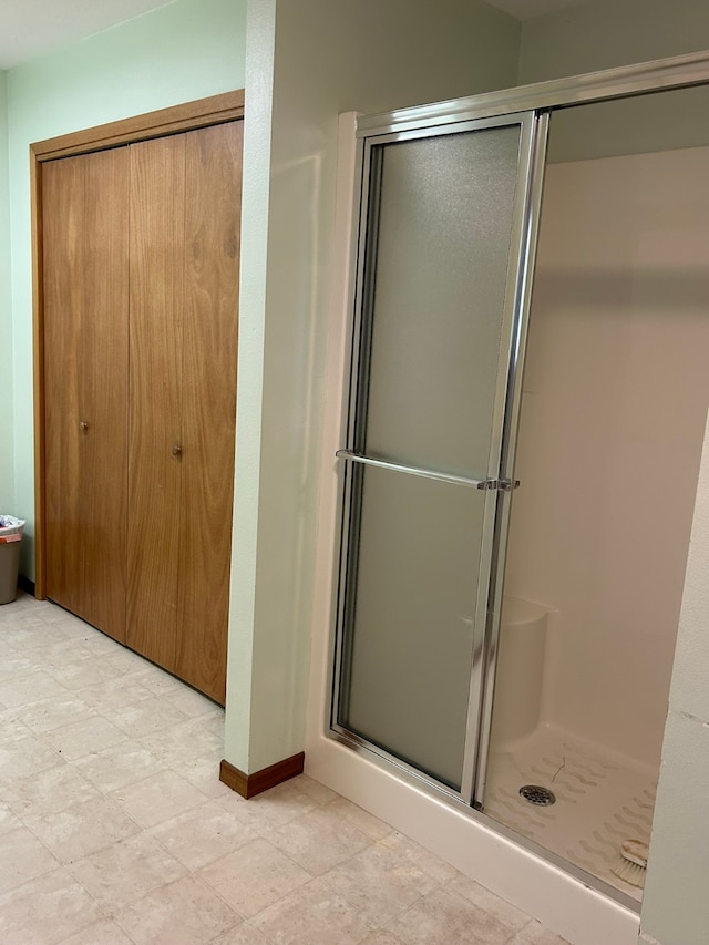 bathroom featuring a shower with shower door