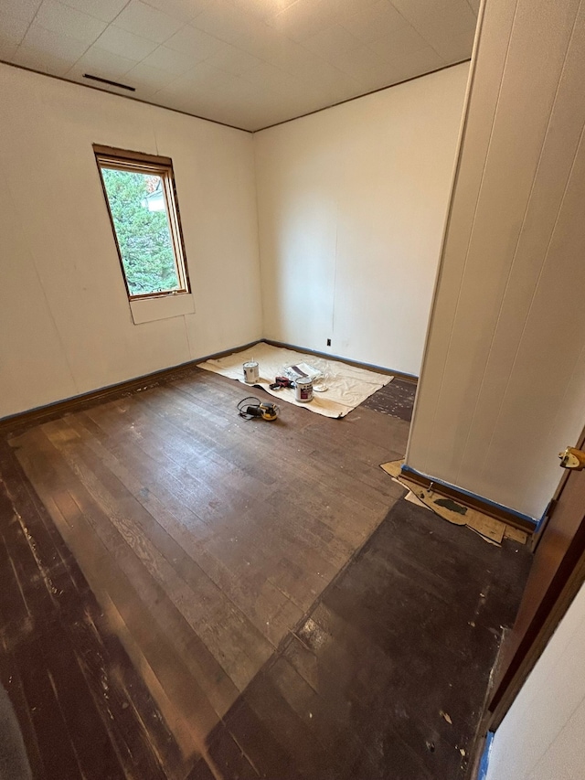 empty room with dark wood-type flooring