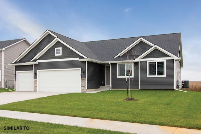 craftsman-style house with a garage, cooling unit, and a front lawn