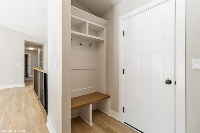 mudroom with light wood finished floors and baseboards