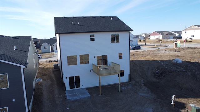 rear view of house featuring cooling unit