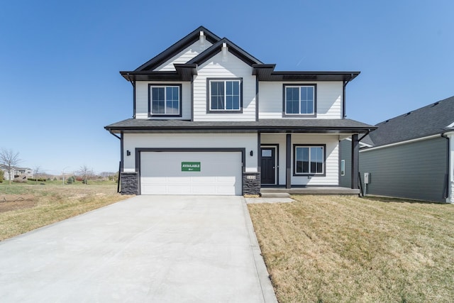 craftsman-style house with an attached garage, a porch, a front lawn, and concrete driveway