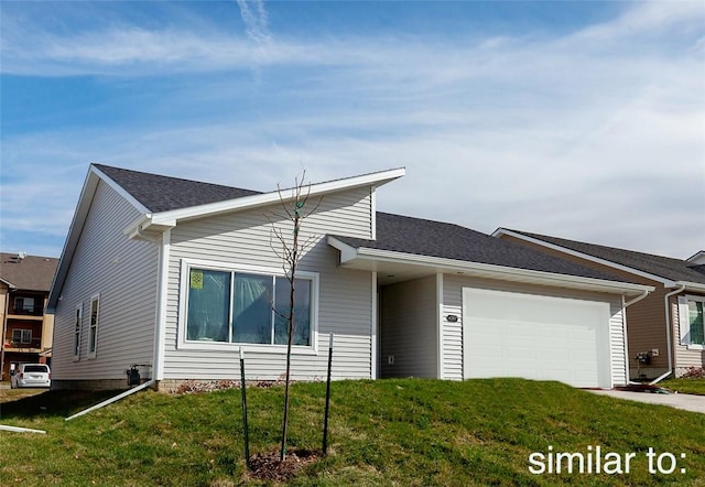 ranch-style home featuring a garage and a front lawn