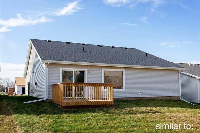 rear view of house featuring a yard and a deck