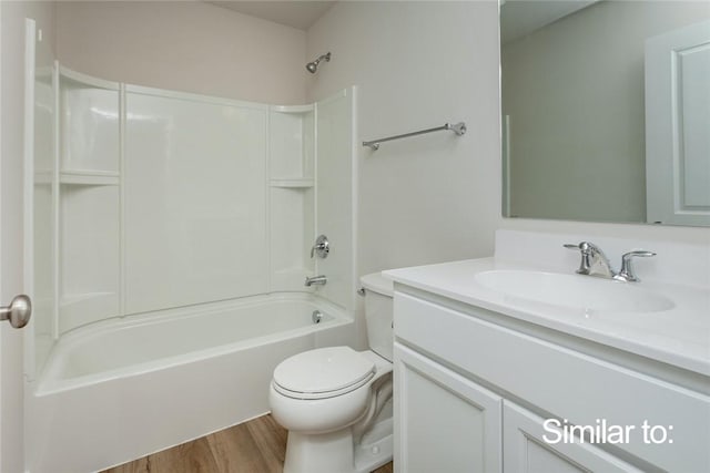 full bathroom featuring shower / tub combination, vanity, hardwood / wood-style floors, and toilet