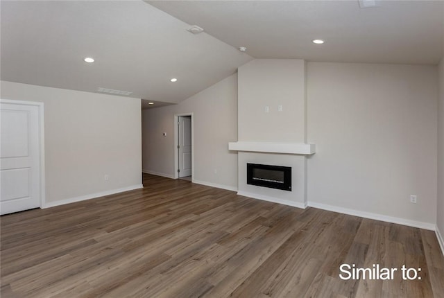 unfurnished living room with lofted ceiling, hardwood / wood-style floors, and a fireplace