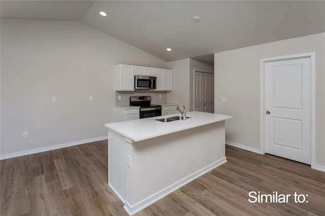 kitchen with sink, light hardwood / wood-style flooring, range with electric cooktop, a kitchen island with sink, and white cabinets