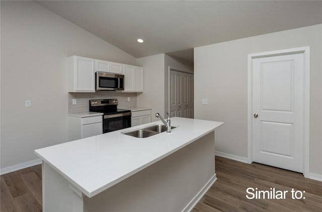 kitchen with sink, appliances with stainless steel finishes, a kitchen island with sink, backsplash, and white cabinets