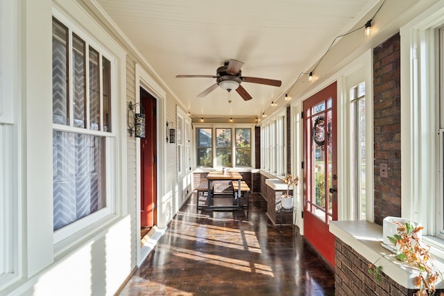 sunroom featuring ceiling fan