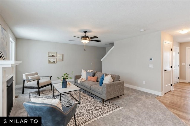 living room with light hardwood / wood-style floors and ceiling fan