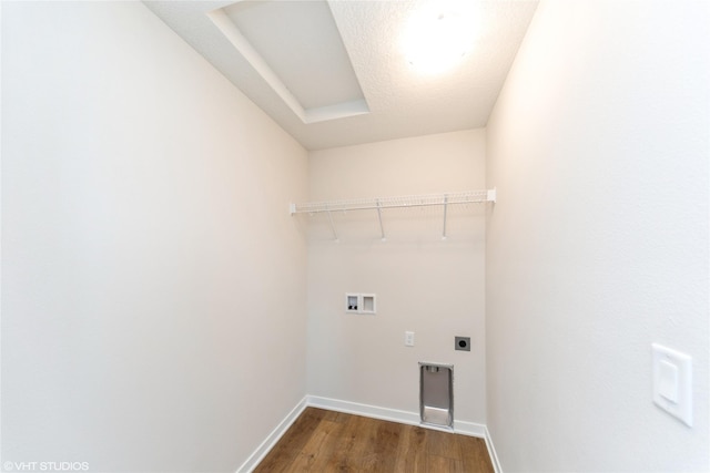 washroom featuring dark wood-style floors, hookup for a washing machine, electric dryer hookup, laundry area, and baseboards