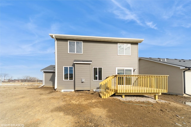 rear view of house featuring a deck