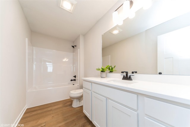 bathroom featuring vanity, shower / bathing tub combination, wood finished floors, and toilet