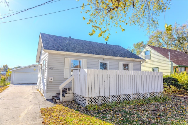 view of front facade featuring a garage and an outdoor structure