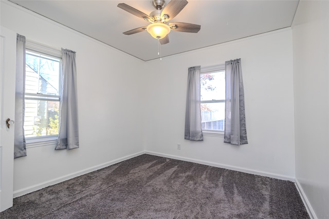 carpeted empty room with a healthy amount of sunlight and ceiling fan