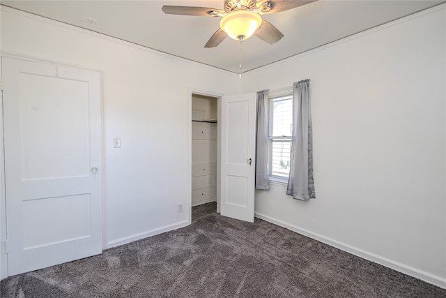 unfurnished bedroom featuring ceiling fan and dark colored carpet