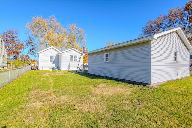 rear view of property featuring a yard