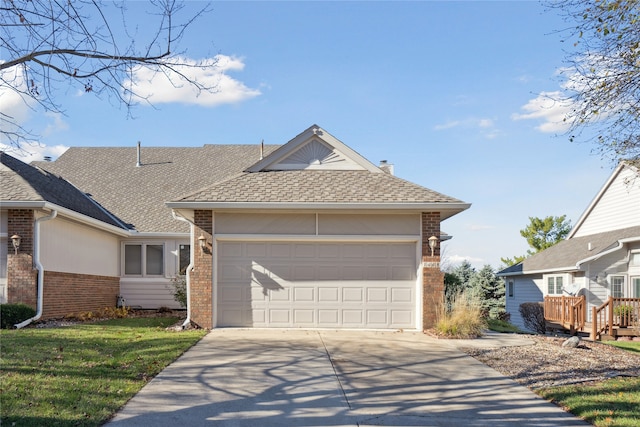 ranch-style house featuring a garage and a front yard