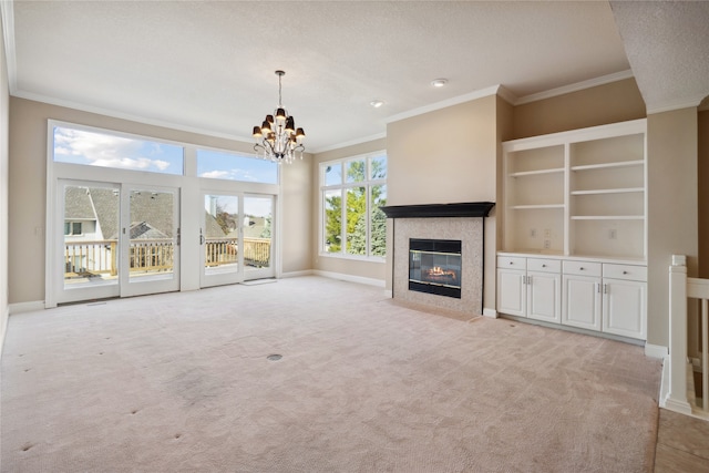 unfurnished living room featuring light colored carpet, a textured ceiling, an inviting chandelier, and crown molding