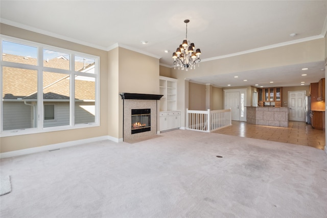 unfurnished living room with ornamental molding, light carpet, and an inviting chandelier