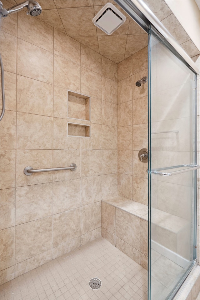 bathroom with a shower with door