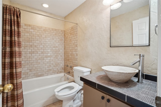 full bathroom featuring toilet, shower / bath combo, and vanity