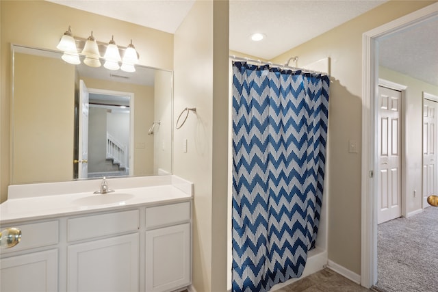 bathroom with vanity, a textured ceiling, and curtained shower