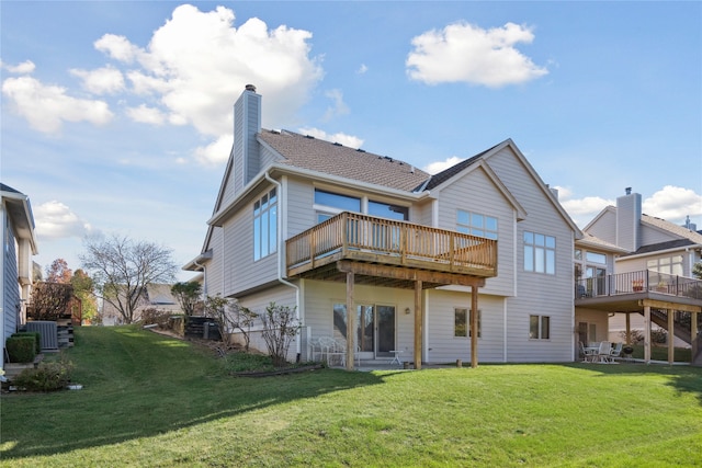 back of property with central AC unit, a yard, and a deck