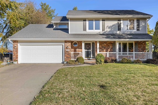 view of front facade with a garage, a front yard, and covered porch