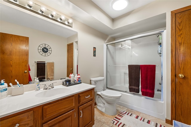 full bathroom featuring tile patterned floors, vanity, toilet, and enclosed tub / shower combo