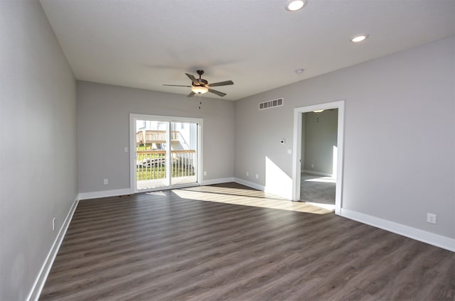 spare room with dark wood-type flooring and ceiling fan