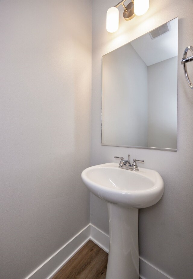 bathroom with hardwood / wood-style flooring