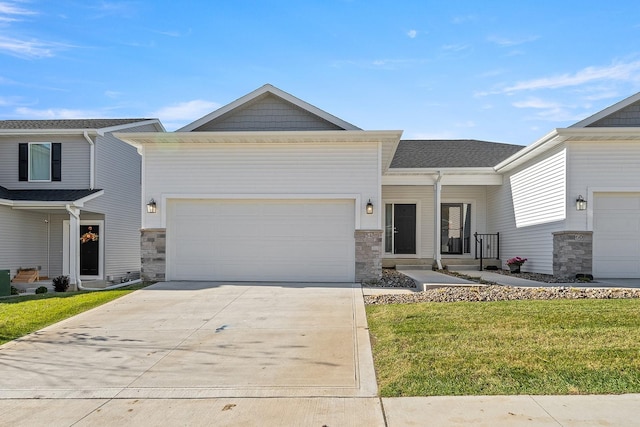 view of front of home with a front lawn and a garage