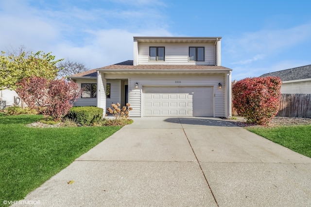 view of front of property with a garage and a front yard