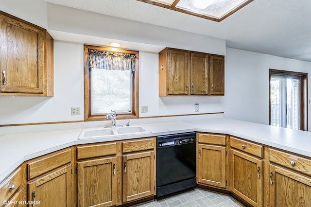 kitchen with kitchen peninsula, sink, black dishwasher, and a textured ceiling