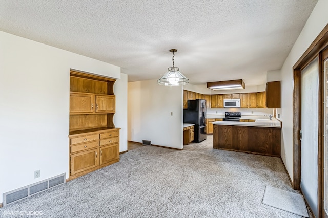 kitchen featuring stainless steel refrigerator, a textured ceiling, decorative light fixtures, light colored carpet, and black range with electric stovetop