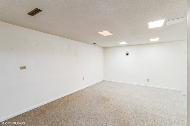 carpeted spare room with a textured ceiling