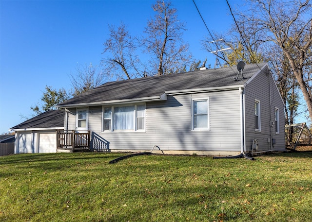 view of front of property with a garage and a front lawn