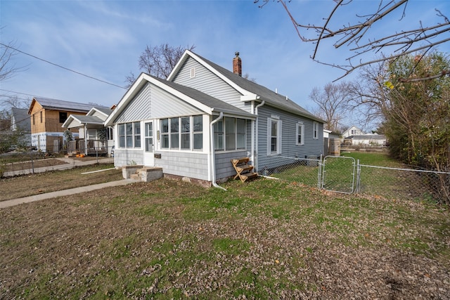 exterior space featuring a lawn and a sunroom