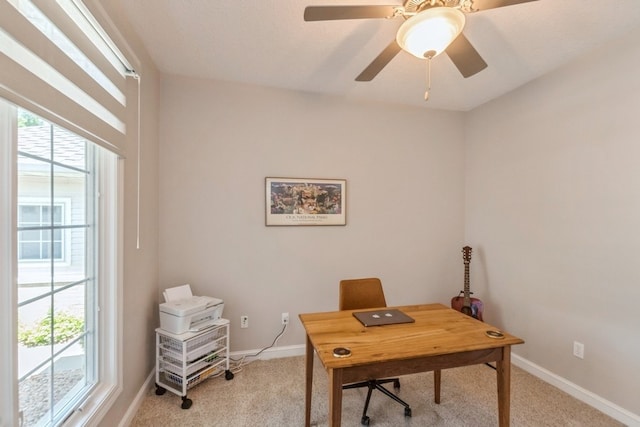 office area featuring light carpet, a healthy amount of sunlight, and baseboards