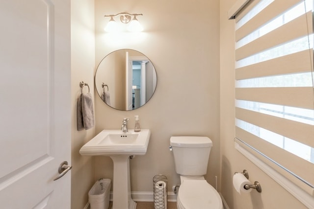 bathroom with baseboards and toilet