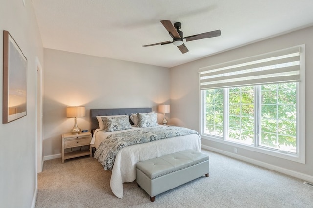 bedroom featuring carpet floors, visible vents, baseboards, and a ceiling fan